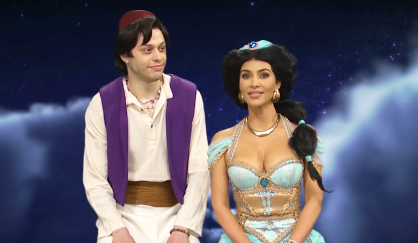 dressed as Jasmine and Aladdin, Kim and Pete ride a magic carpet in an SNL sketch