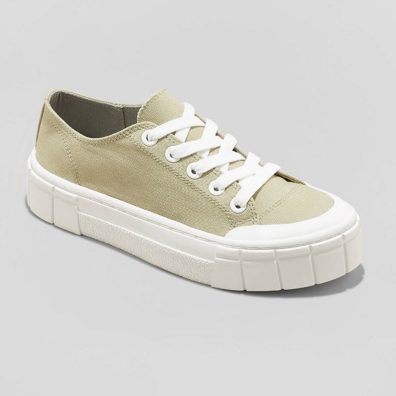 the green sneaker with white sole