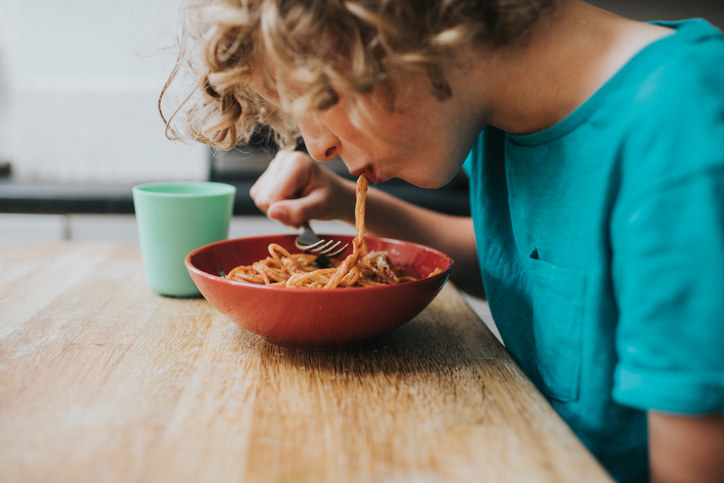 Child eating pasta