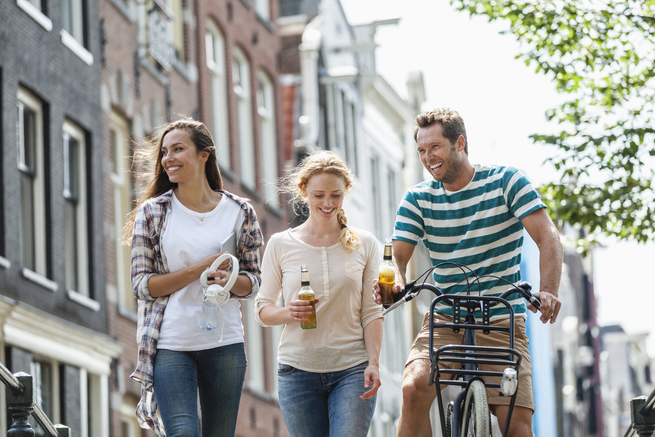 a group enjoys drinks while walking down the street