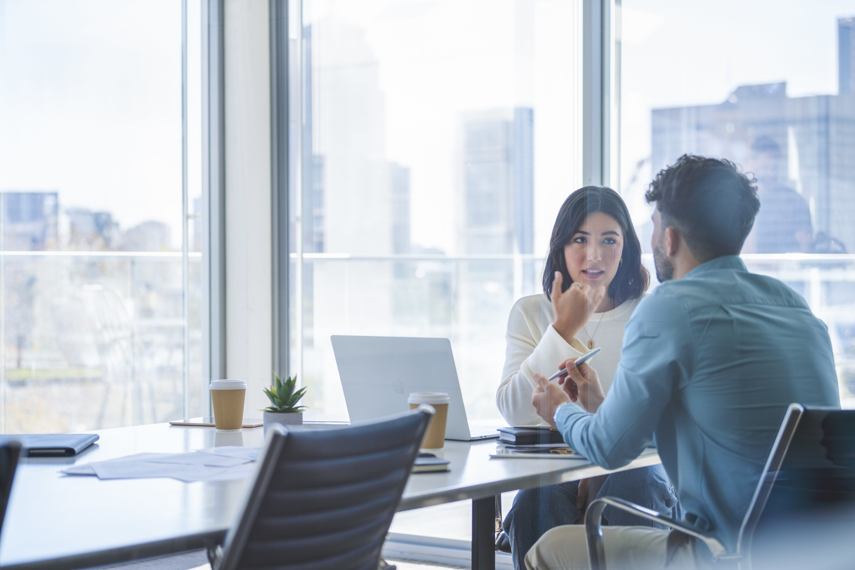 A man and a woman at a table in a conference room