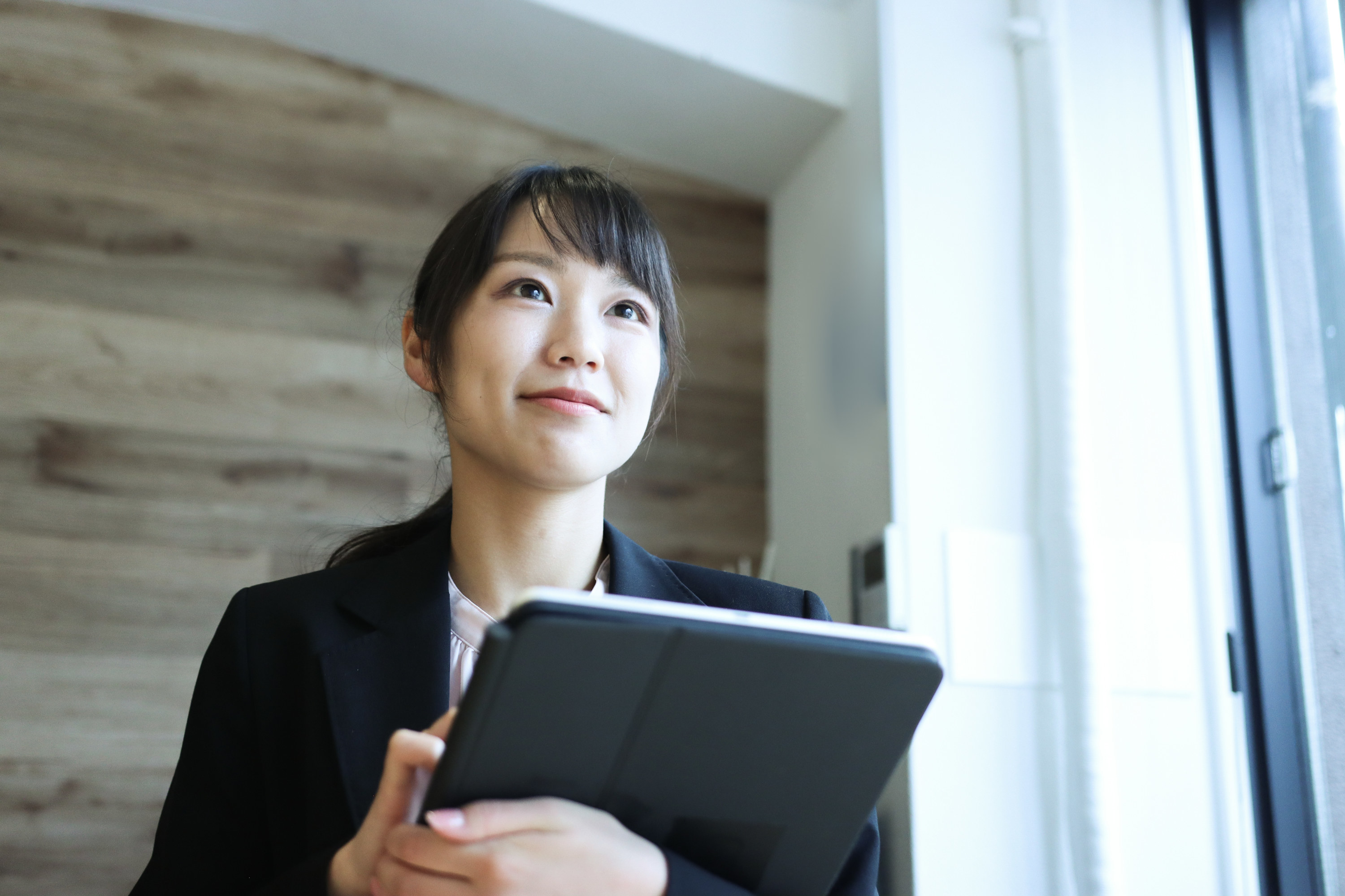 Woman in suit with iPad