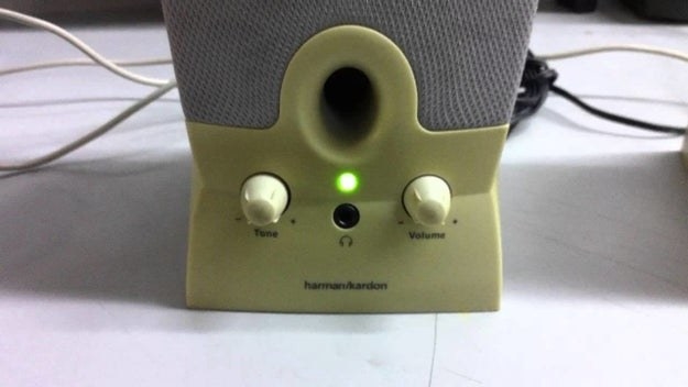 Close-up of an external computer speaker with the green light on