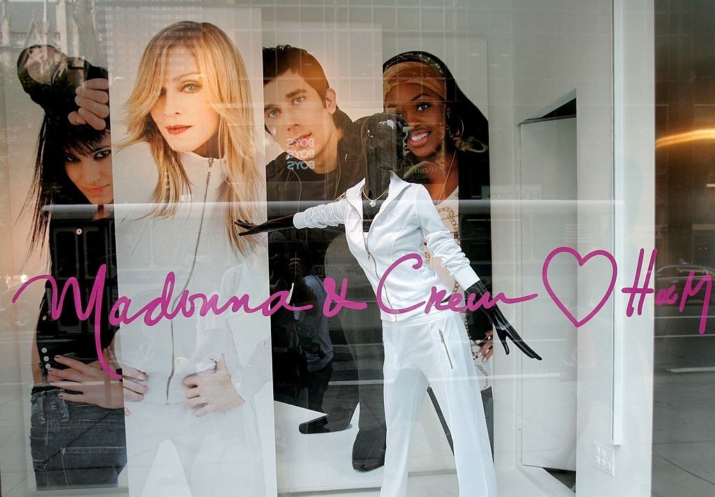 H&amp;amp;M window display featuring a white tracksuit and photo of Madonna wearing it