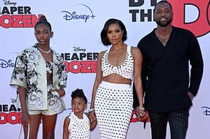 Gabrielle Union and Dwyane Wade holding hands with their daughters Kaavia and Zaya Wade