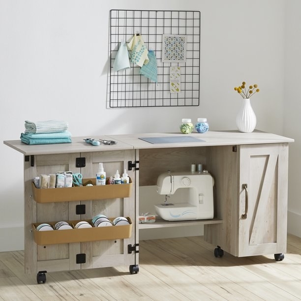 the sewing table in a light beige wooden color