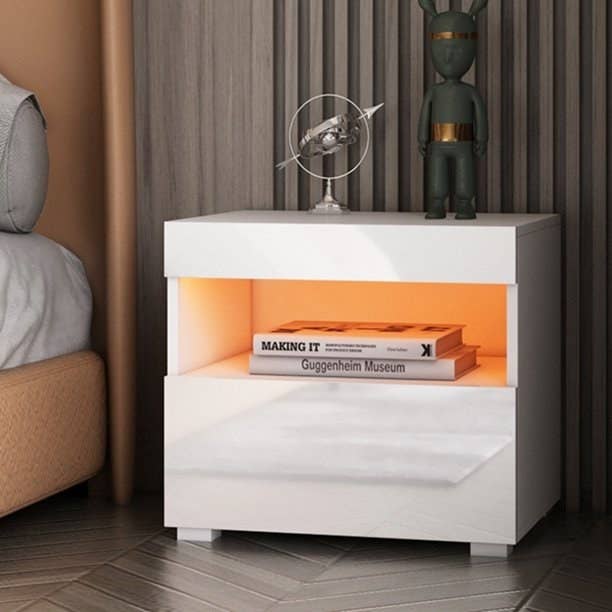 the nightstand in white with a shelf lit up by an LED light