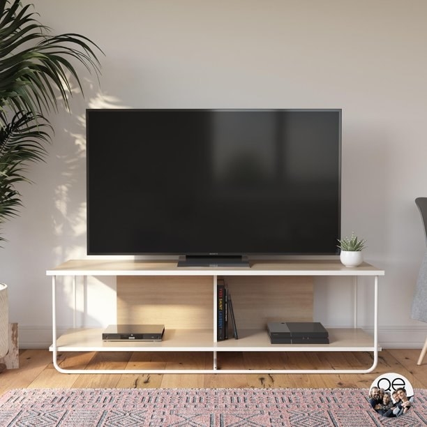 the tv stand in white with two shelves