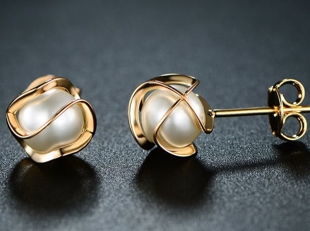 A pair of gold and pearl earrings