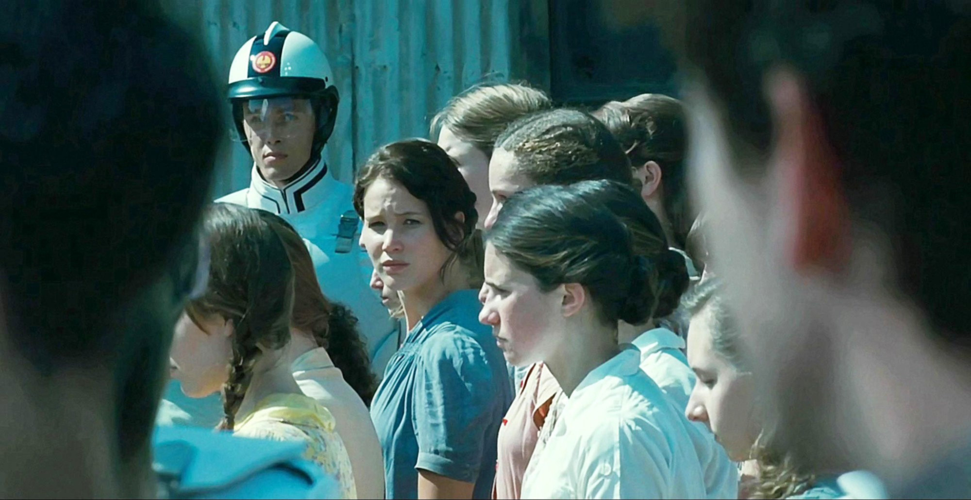 Katniss looking to the side in a crowd