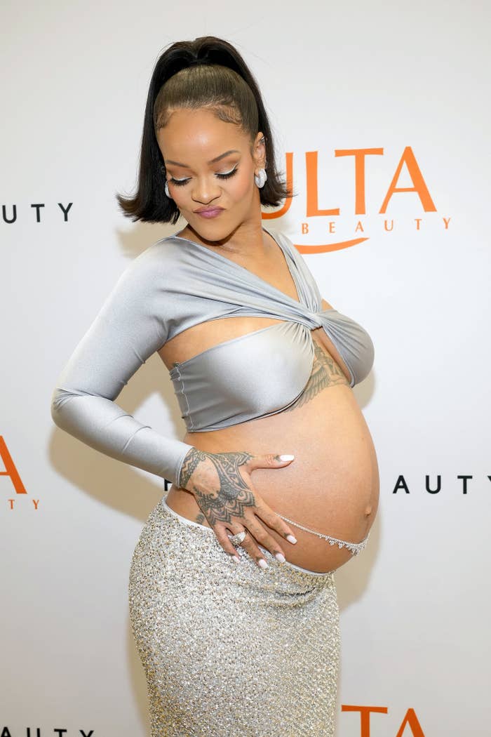 Rihanna poses while showing off her baby bump
