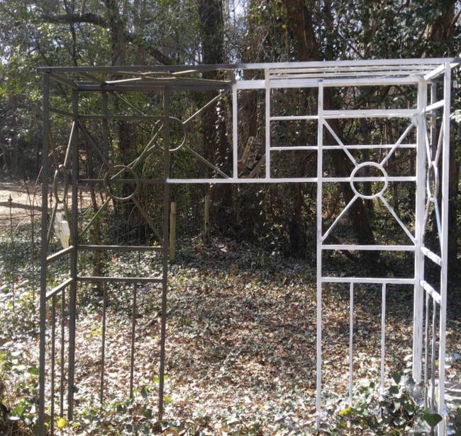 reviewer's half painted metal garden archway