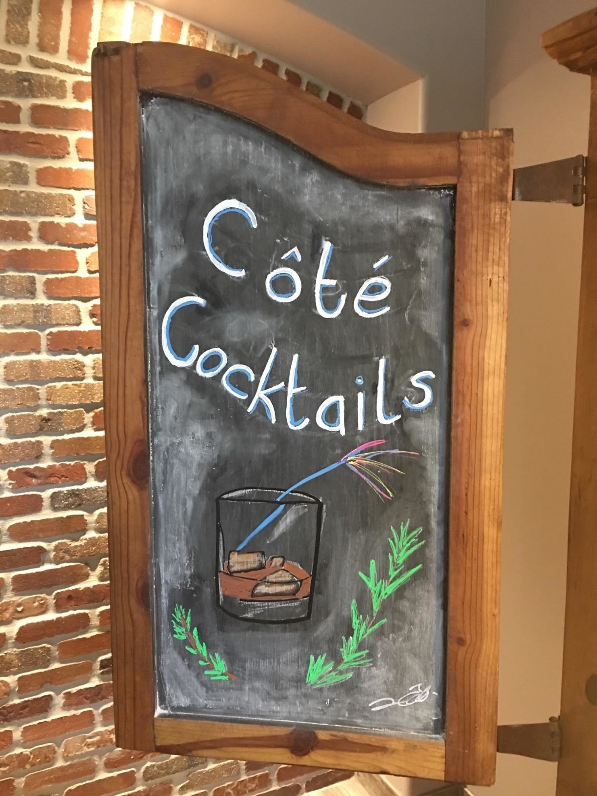 reviewer image of a door to an old TV unit they converted to a mini bar, using the chalkboard paint to turn the door into a chalkboard with a cocktail drawn on it and the words &#x27;Côté Cocktails