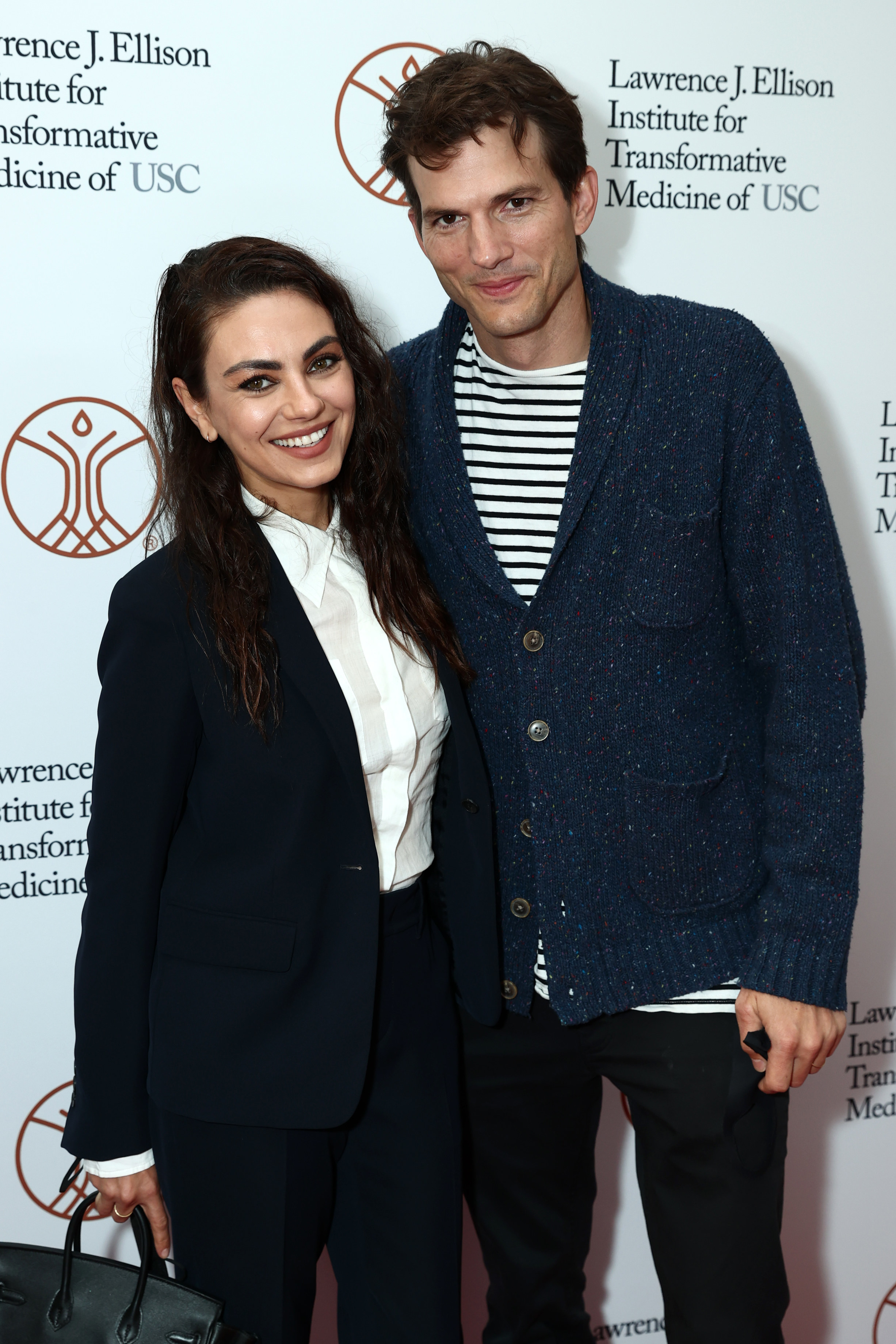 Mila Kunis and Ashton Kutcher attend the Grand Opening of the Lawrence J. Ellison Institute