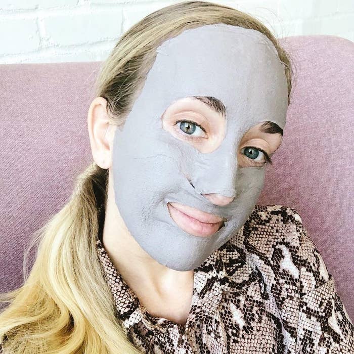 a person wearing the mud sheet mask while looking into the camera