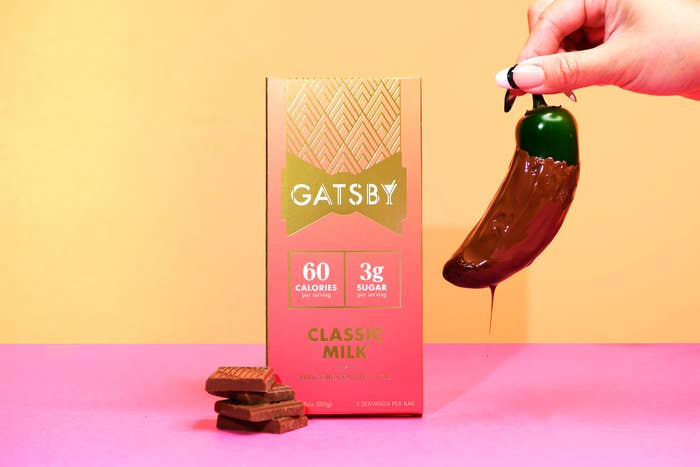 A Gatsby milk chocolate bar next to a chocolate covered jalapeno