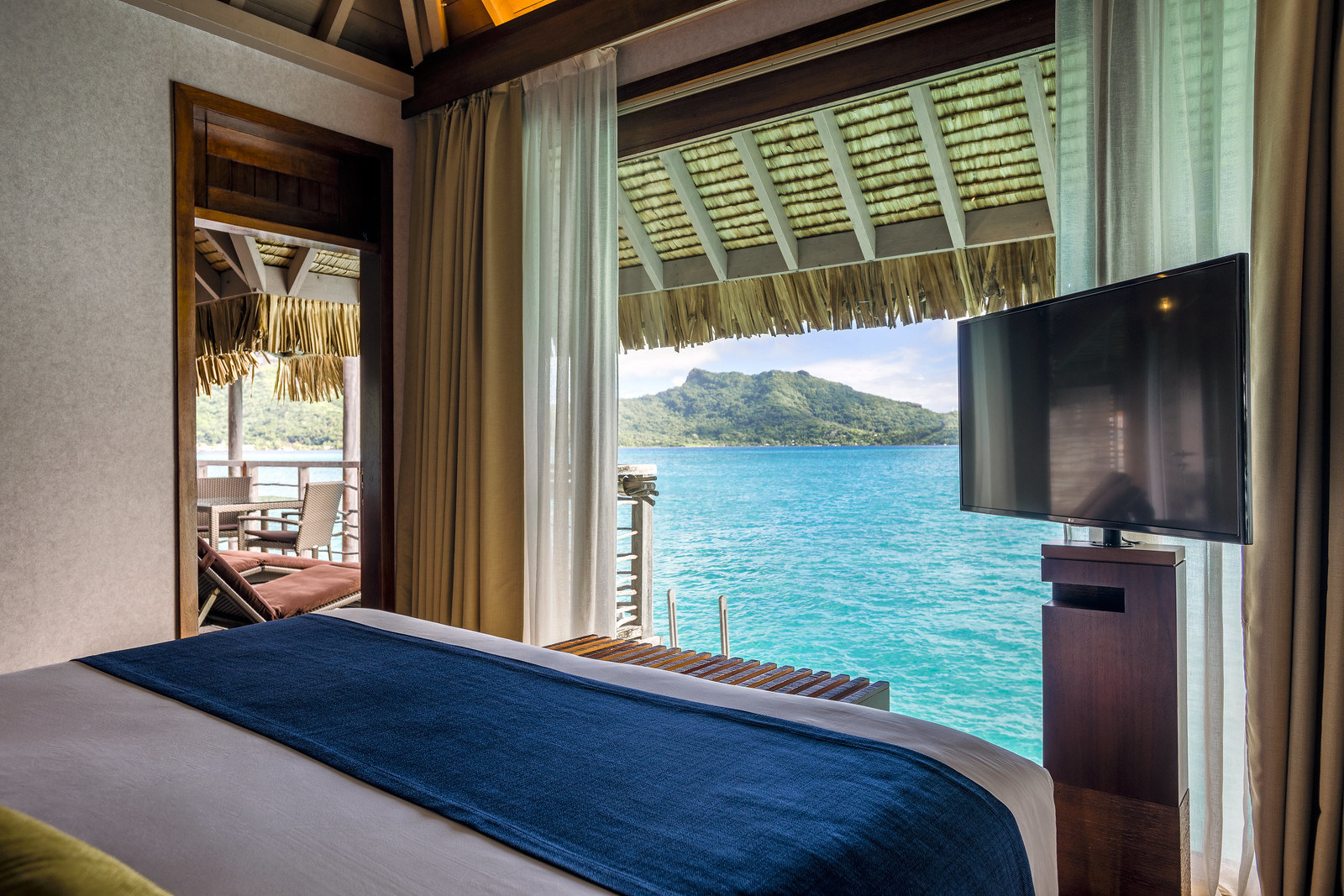 A view from the bedroom of one of the villas, which features a large picture window overlooking the ocean