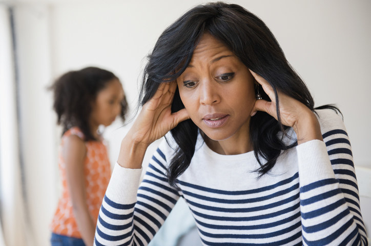 Parent looking frustrated with child behind them