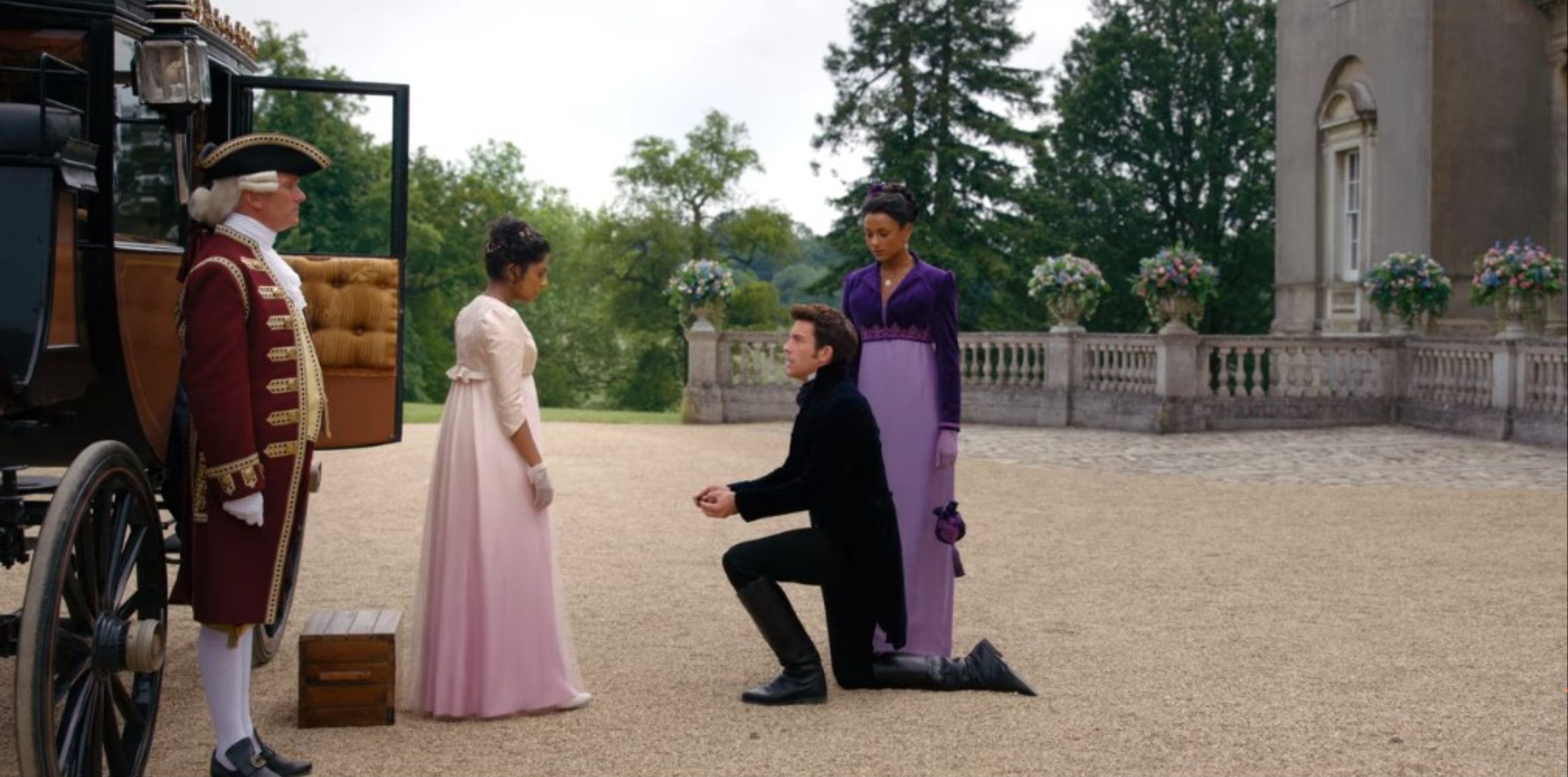 Anthony, down in one knee, proposing to Edwina while Kate stands to the side.