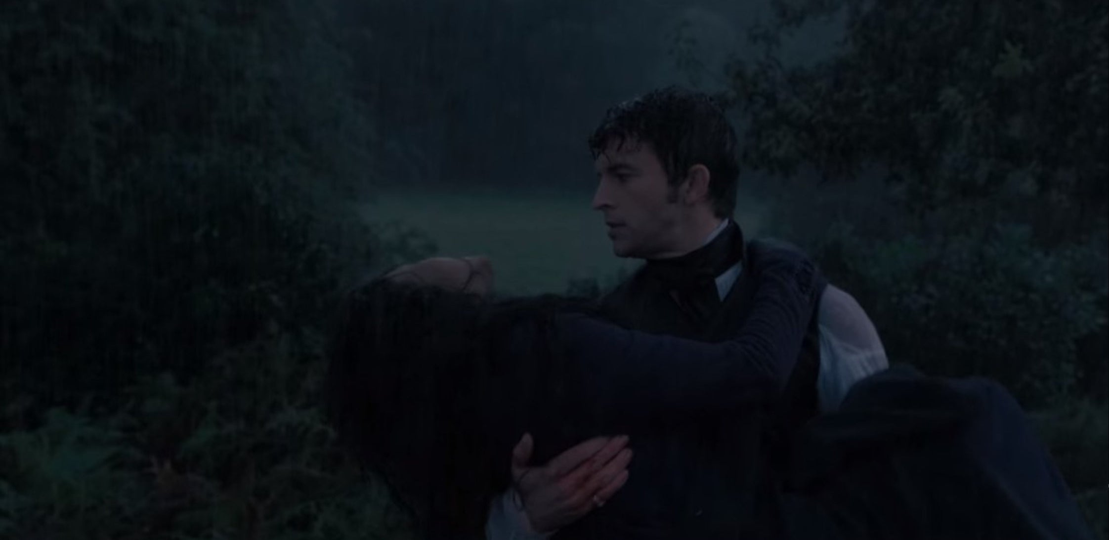 Anthony holding Kate after she got tossed off from the horse in the rain.