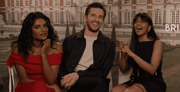 3 of the cast members laughing while being interviewed