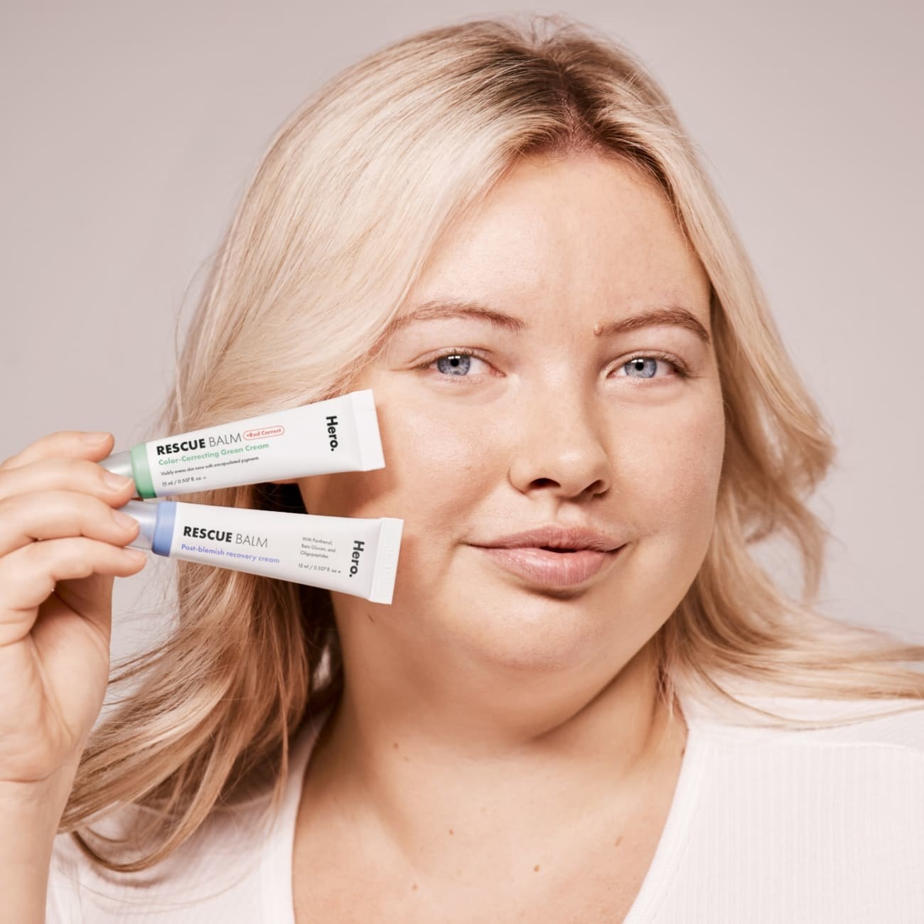 Model holding the Hero Cosmetics rescue and redness AM/PM set