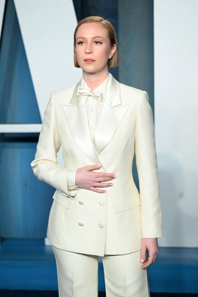Hannah in a light-colored bow tie and pantsuit