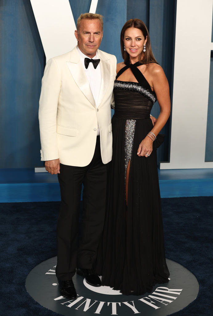 Kevin in a bow tie and light-colored jacket and Christine in a long gown