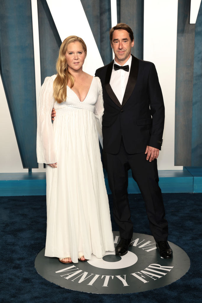 Amy in a long, light-colored gown and Chris in a bow tie