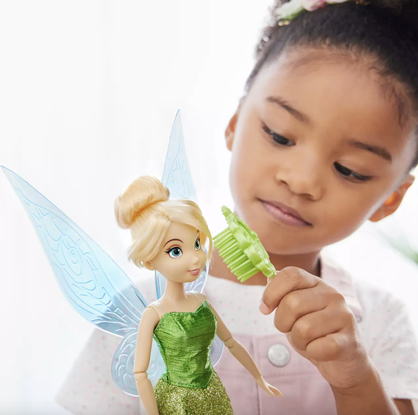 child playing with tinkerbell doll
