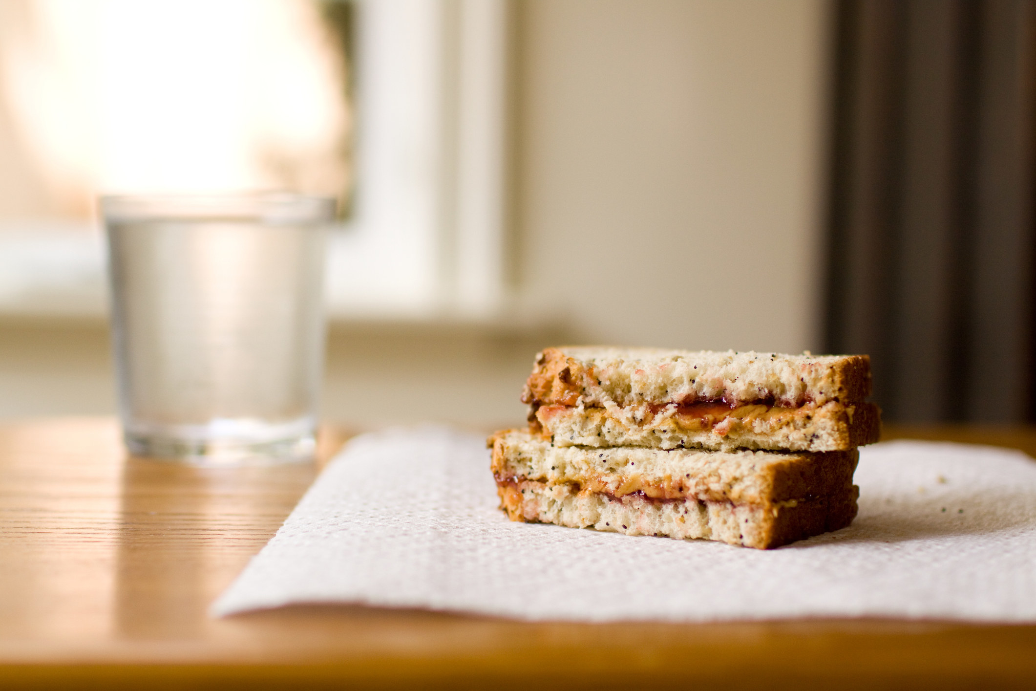 A sliced peanut butter sandwich on a napkin.