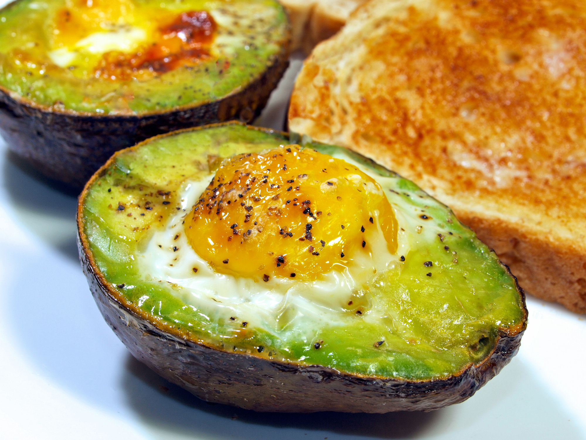 Baked egg and avocado with a side of toast