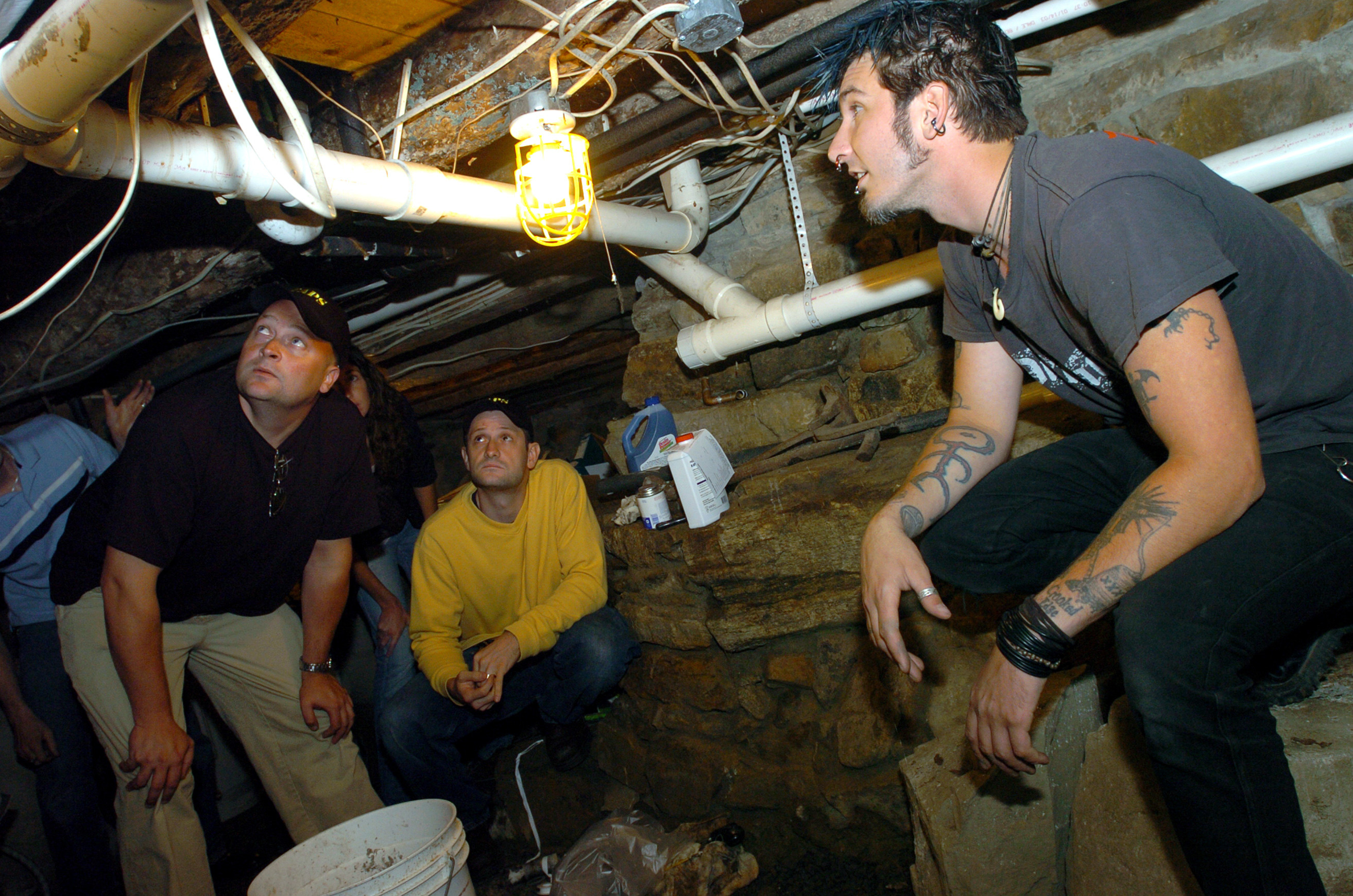Cast of ghost hunters in a basement