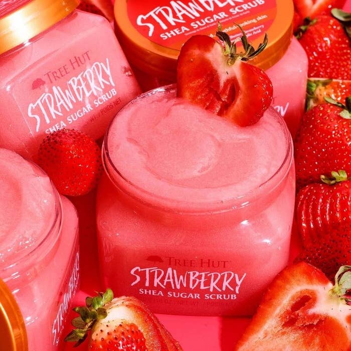 A jar of pink body scrub with strawberries