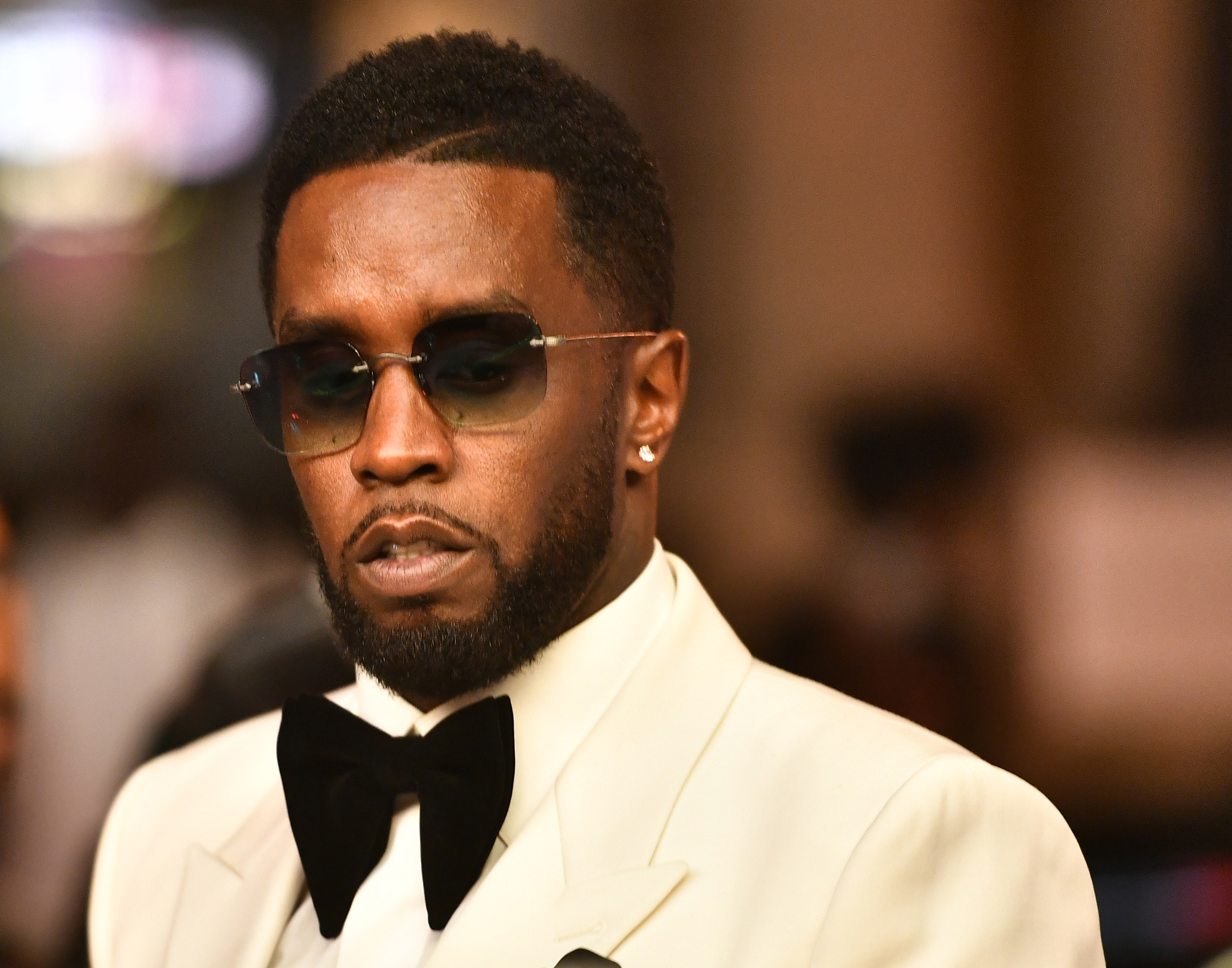 Diddy in sunglasses and a bow tie