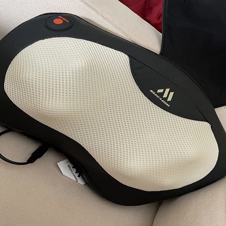 reviewer's black massager on a couch