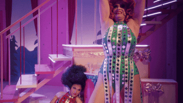 gif of jinkx and dela doing jazz hands during a holiday special