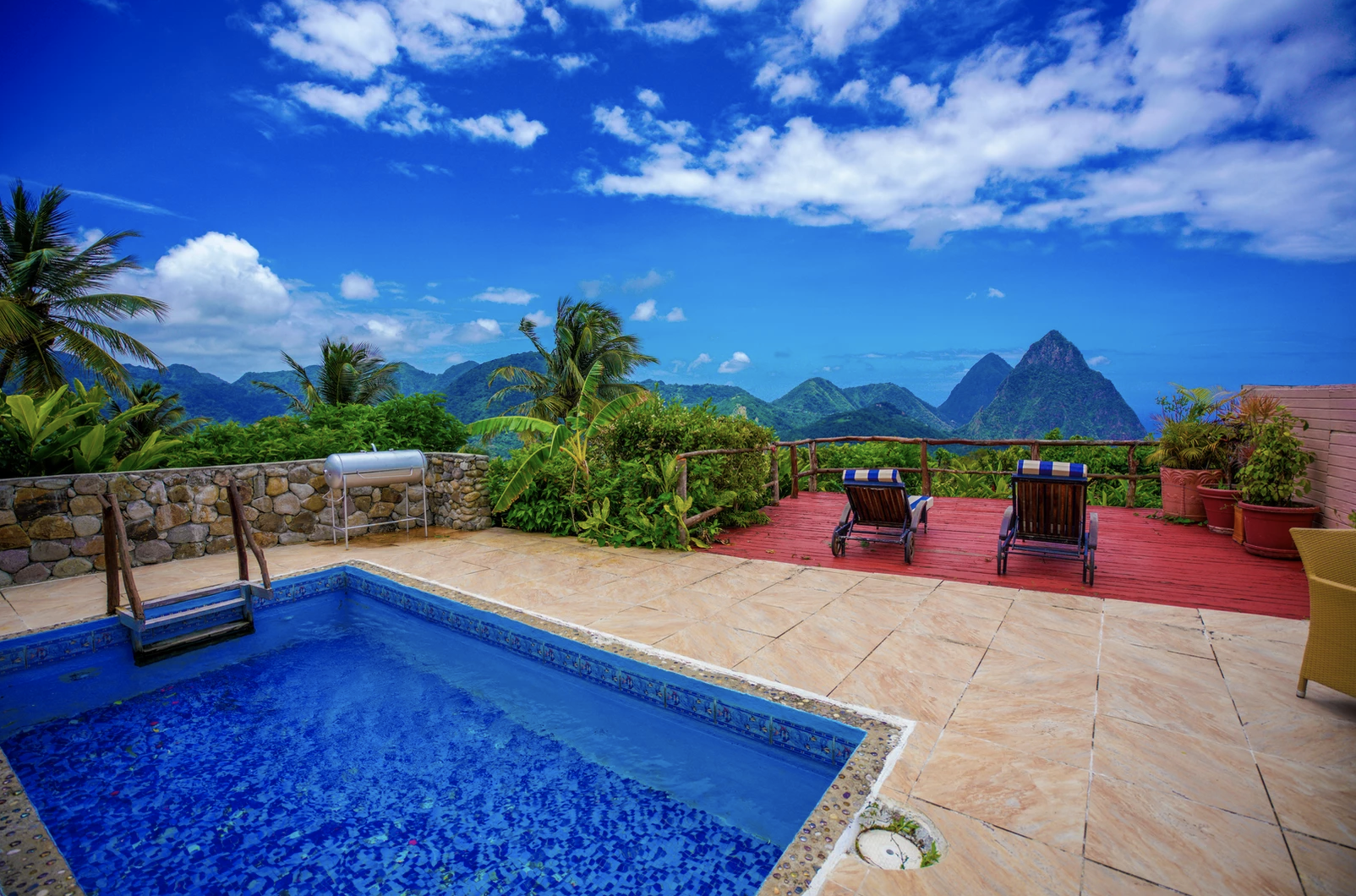 A private patio at the hotel with a plunge pool and a beautiful high-up view of mountains in the distance