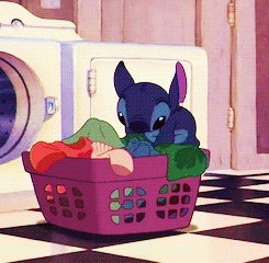 GIF of Stitch from &quot;Lilo &amp;amp; Stitch&quot; standing on top of laundry basket