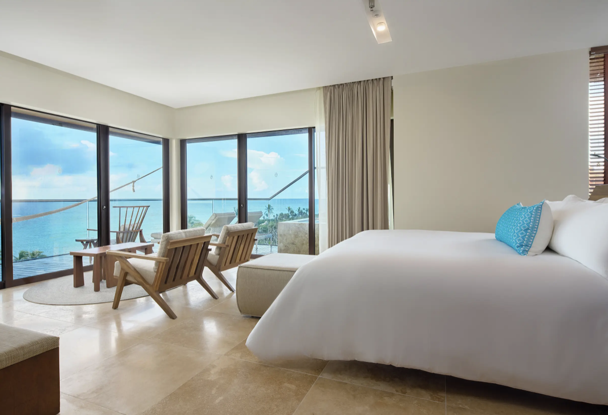 A room at the hotel featuring floor-to-ceiling windows that overlook the ocean