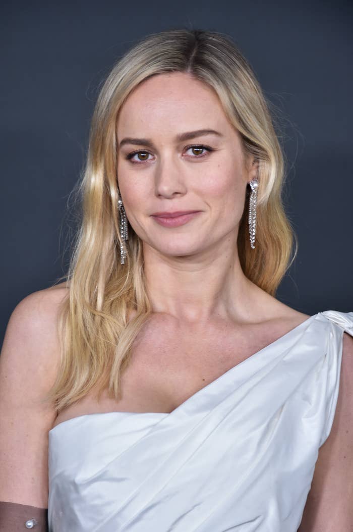 A close up of Brie wearing a dress with one strap