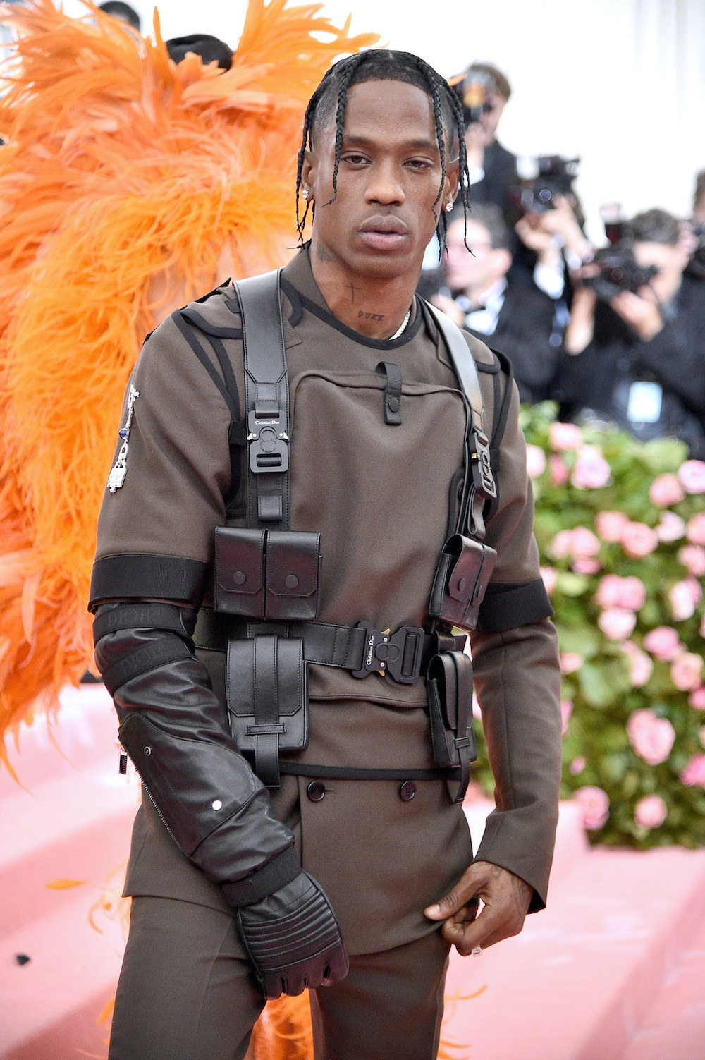 Travis Scott wearing a structured suit with leather belted harness for the Met