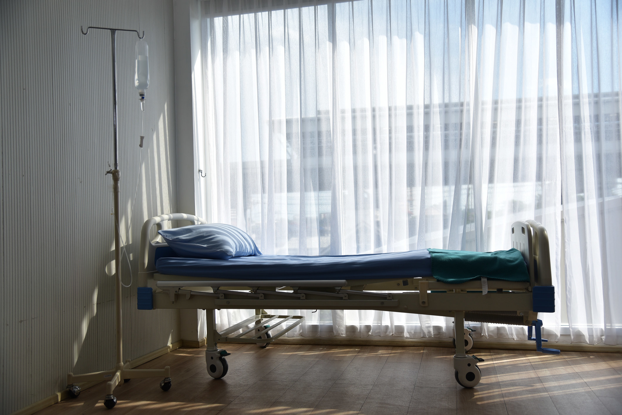 A hospital bed next to a window