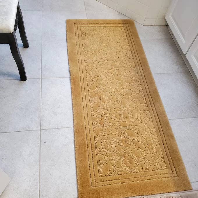 Reviewer photo of the gold bath rug