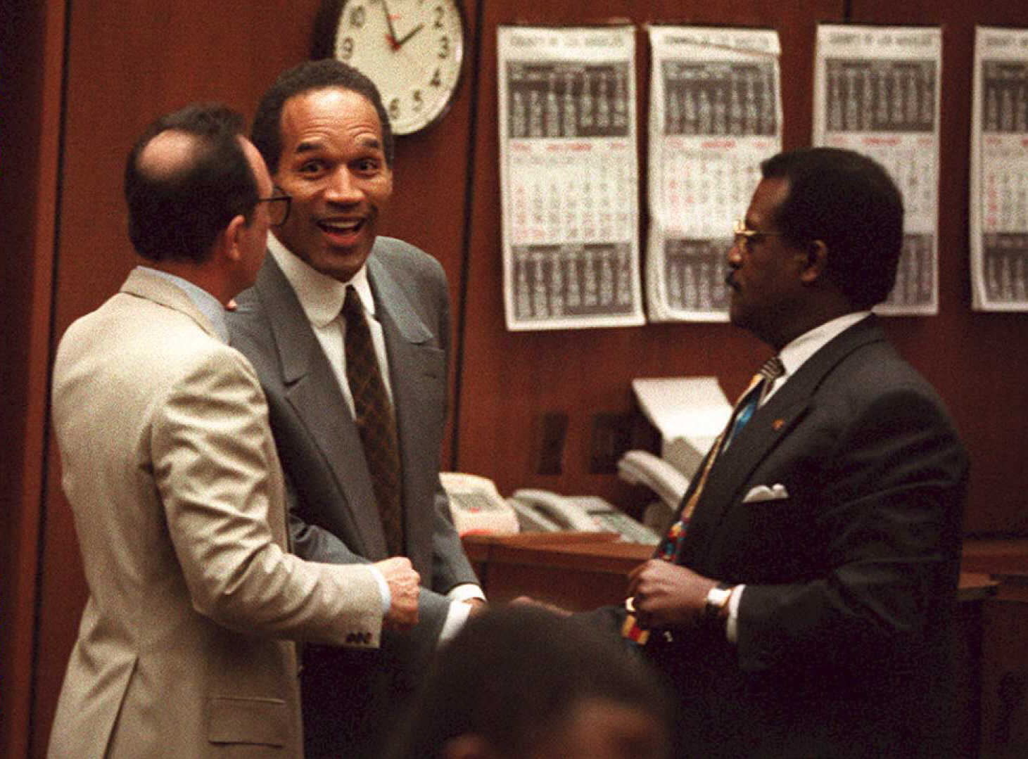 O.J. Simpson laughs with Robert Shapiro and Johnnie Cochran