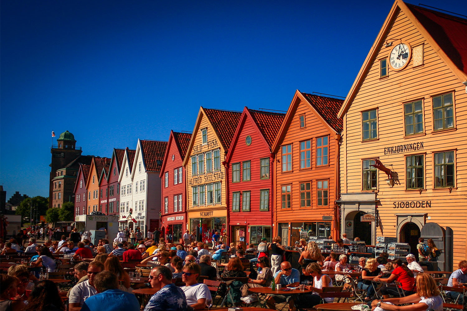 People dining outside in a town square.