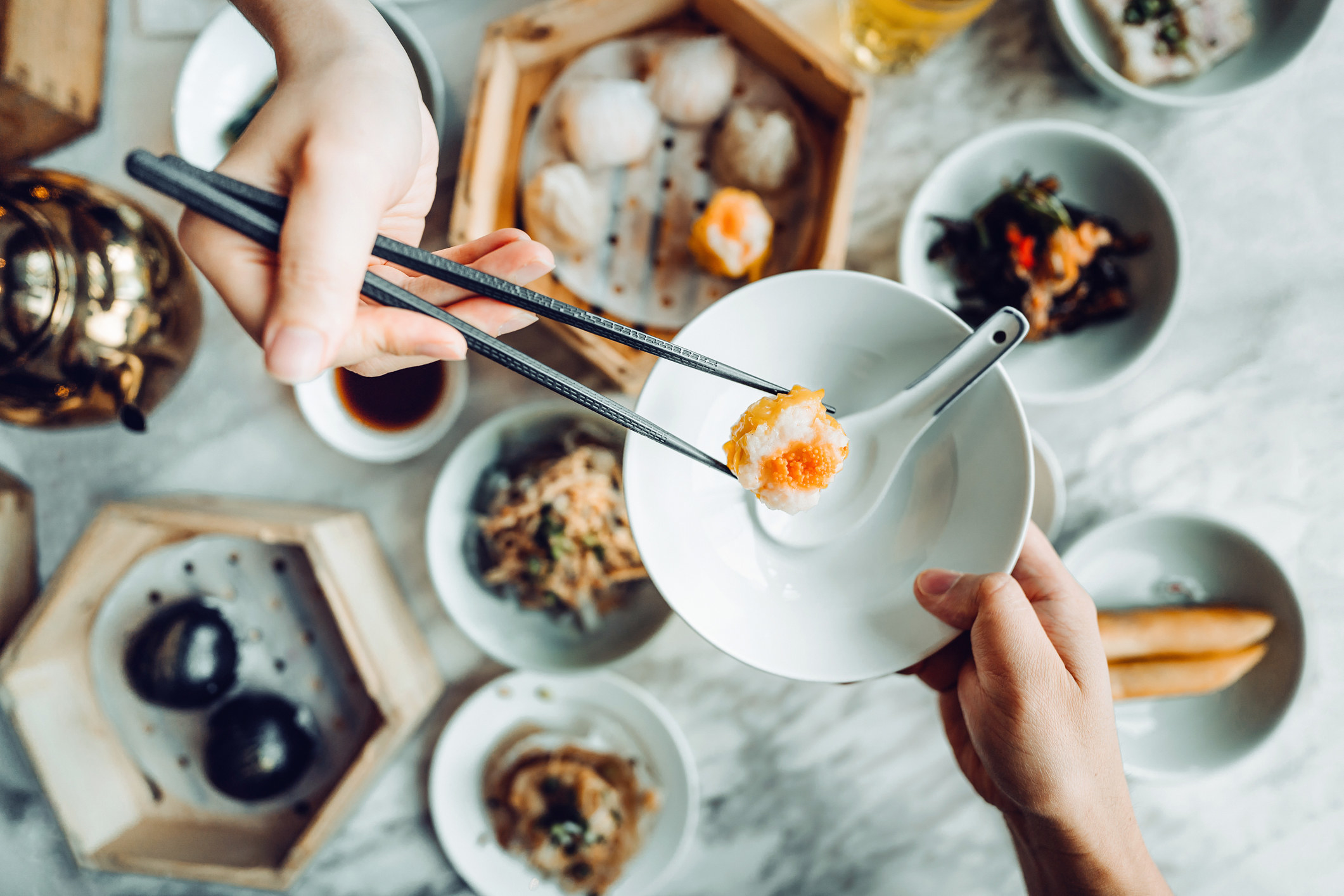 People eating dum sum at a restautant.