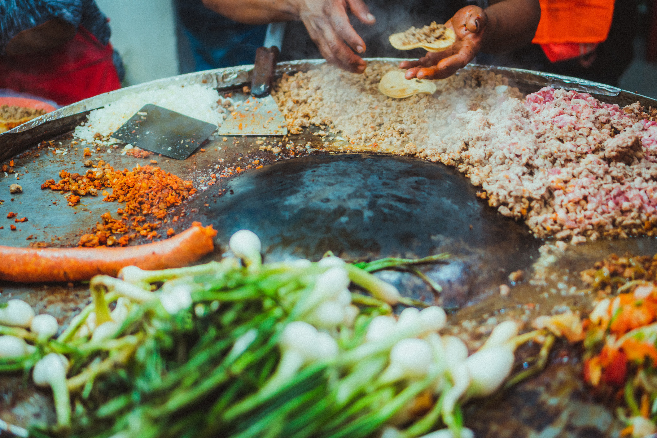 Close up of a Mexican hands making tacos at the street.