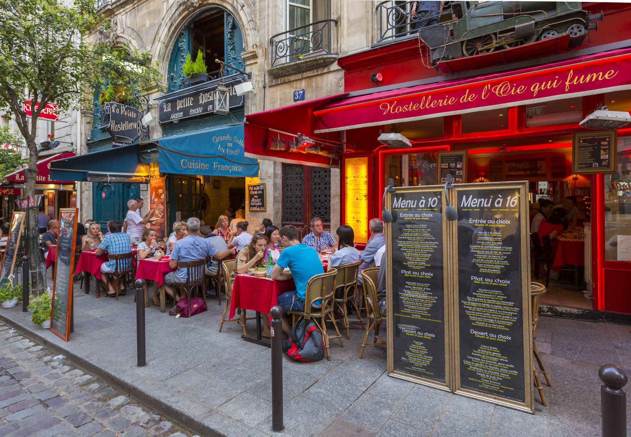 People eating outdoors at a Parisian bistro