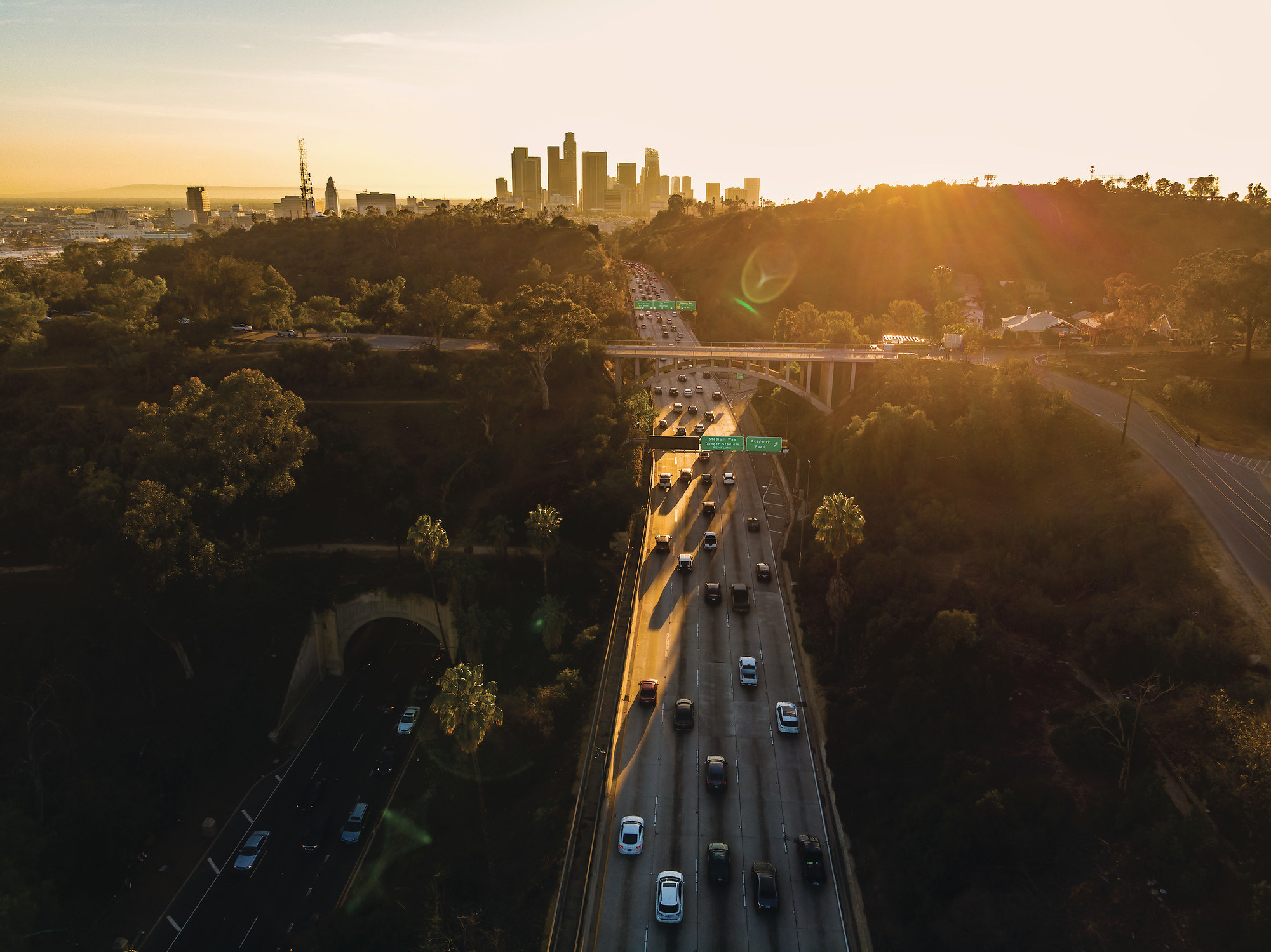 Cars on a highway driving towards a city.